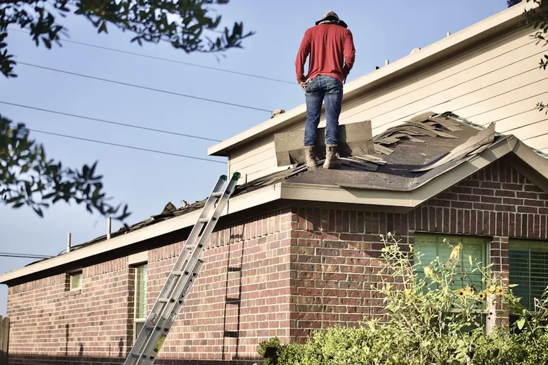 Professional roofer working on a residential roof in Dresher